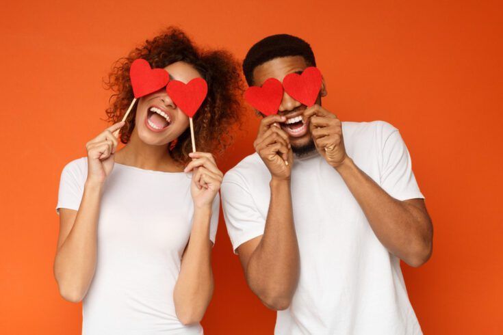 Black couple with heart props